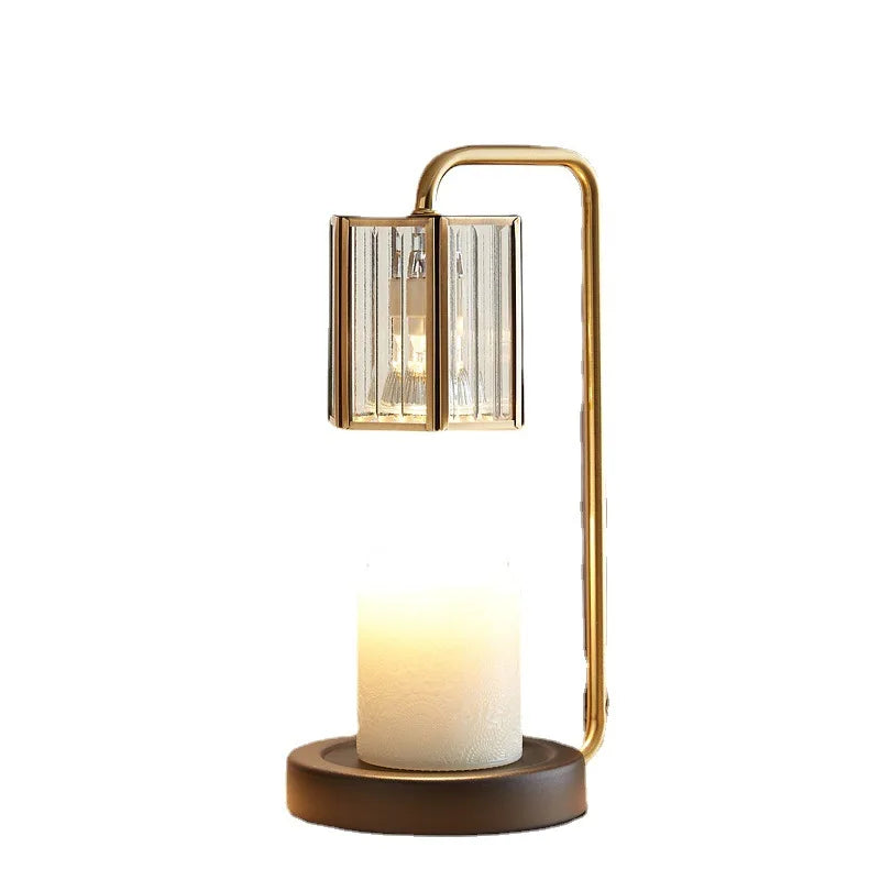 Decorative table lamp with gold frame and candle-like base on a white background