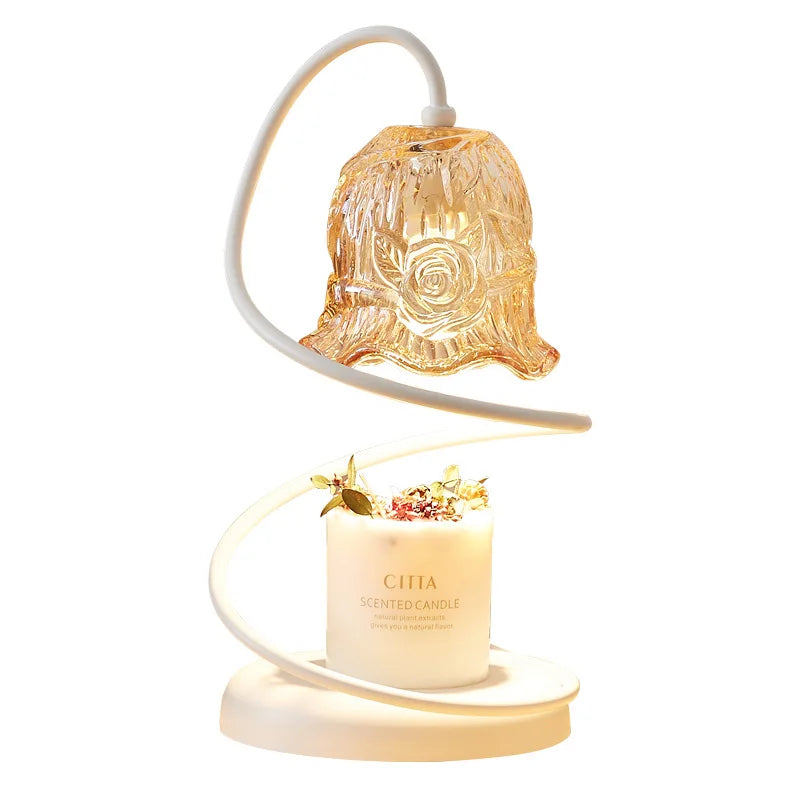 Decorative candle with a glass rose design on top and a white base.