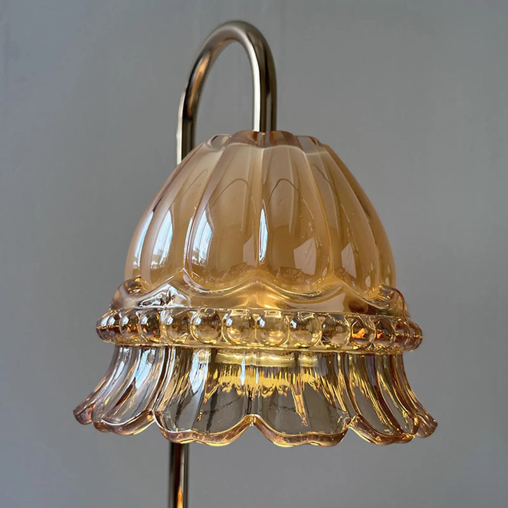 Decorative glass lampshade with a scalloped edge on a plain background