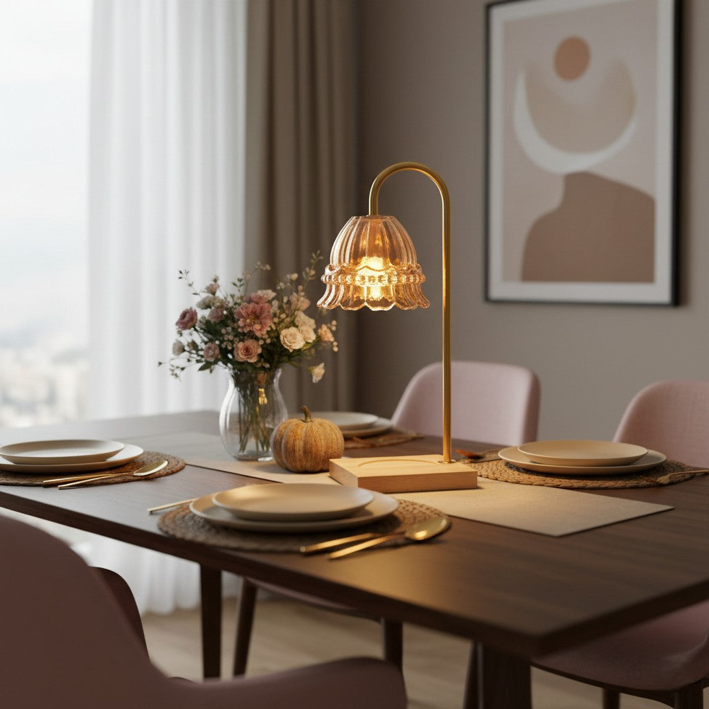 Dining table setting with a decorative lamp, plates, and flowers in a softly lit room.