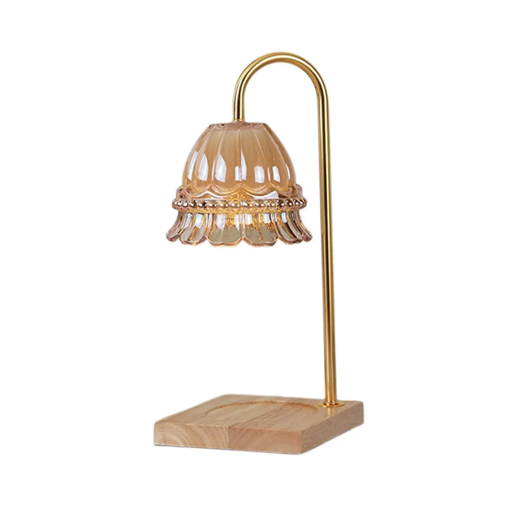 Table lamp with gold metal shade and wooden base on a white background