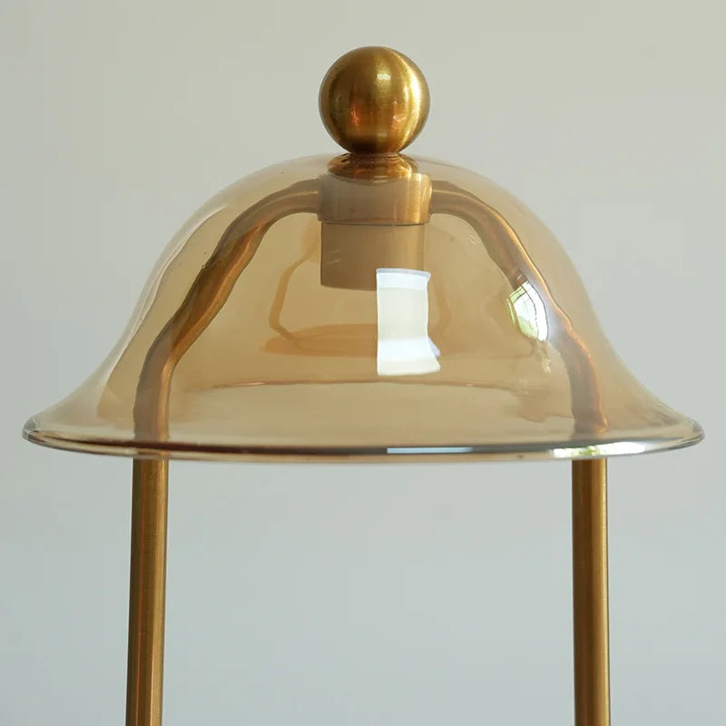 Gold dome-shaped lamp with a plain background