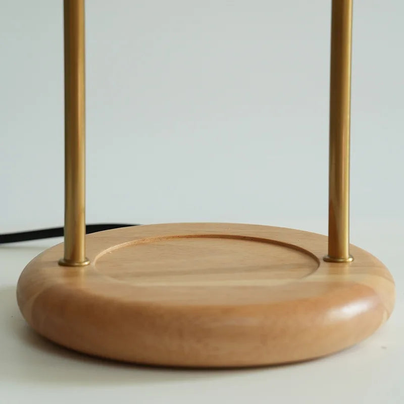 Wooden stand with gold metal rods on a light background