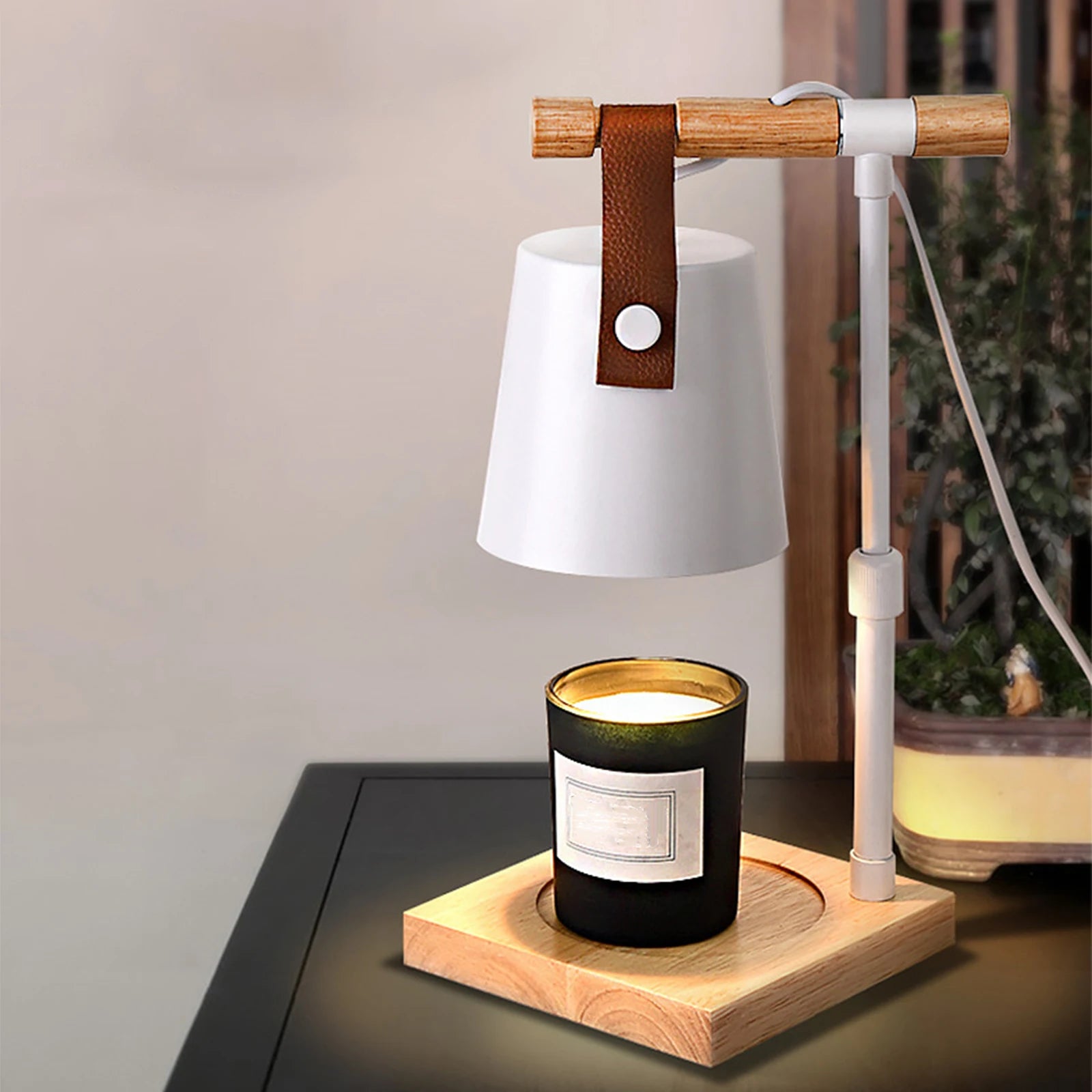 Table lamp with a candle on a wooden base, emitting a warm glow.