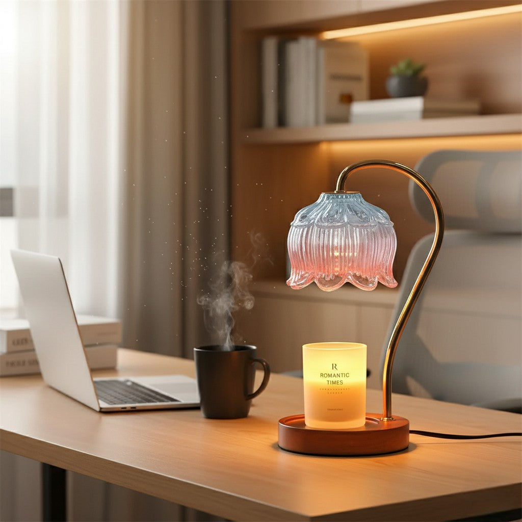 Decorative lamp with a candle on a desk next to a laptop and mug