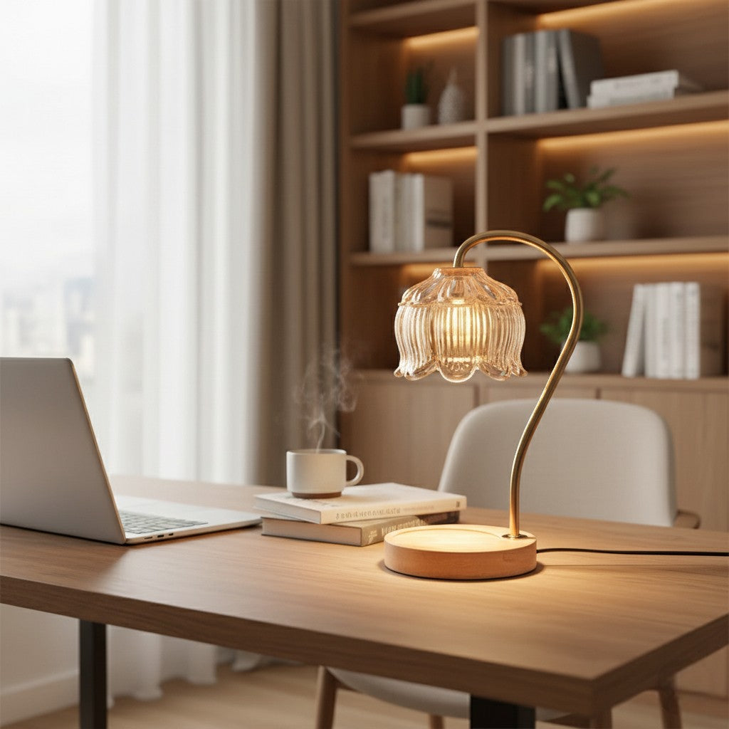Wooden desk with a lamp, laptop, and books in a room with a bookshelf.