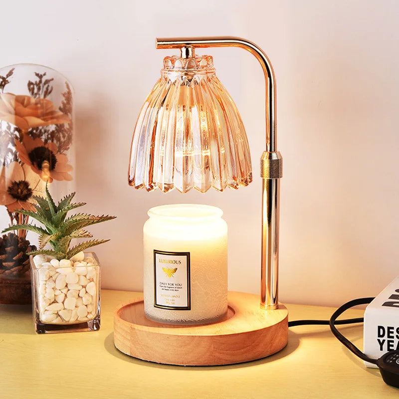 Decorative lamp with a candle on a wooden base, surrounded by plants and decor items.