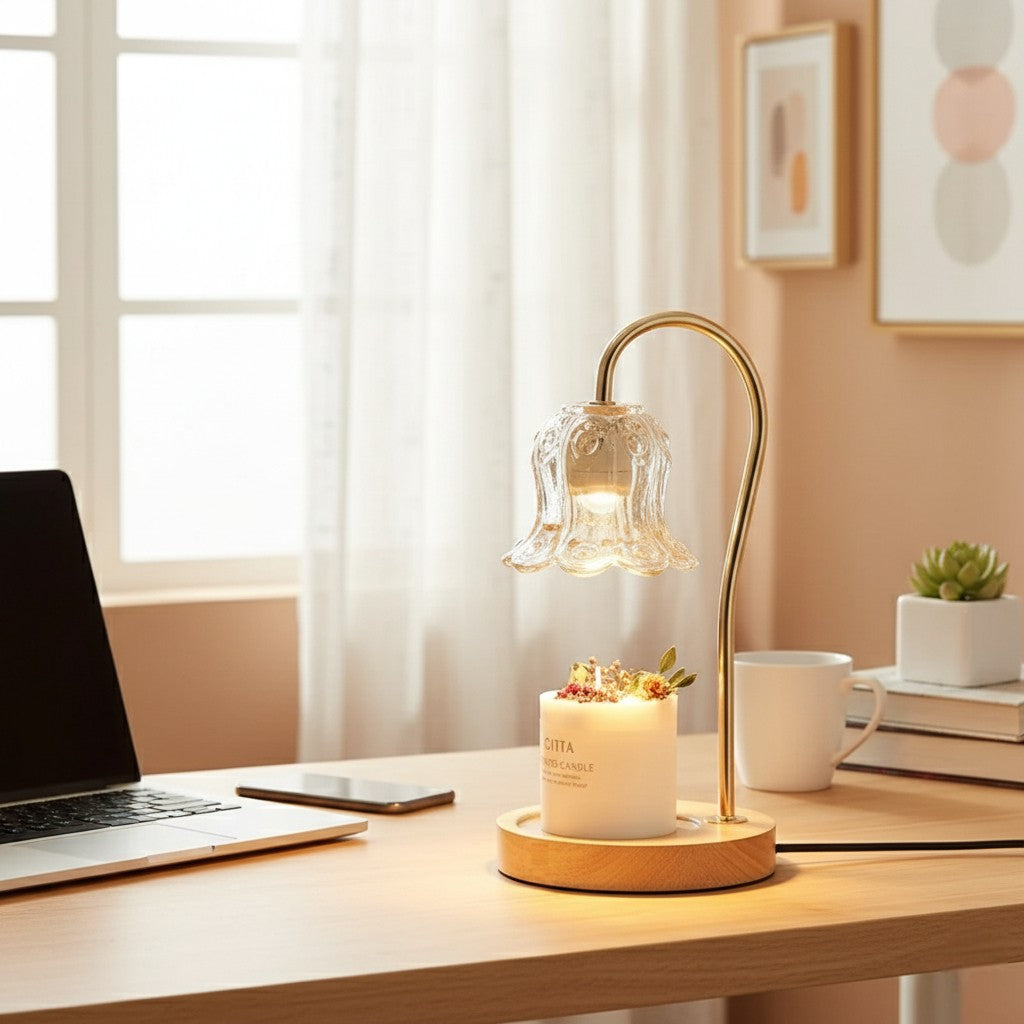 Desk setup with a lamp, laptop, and books in a bright room.