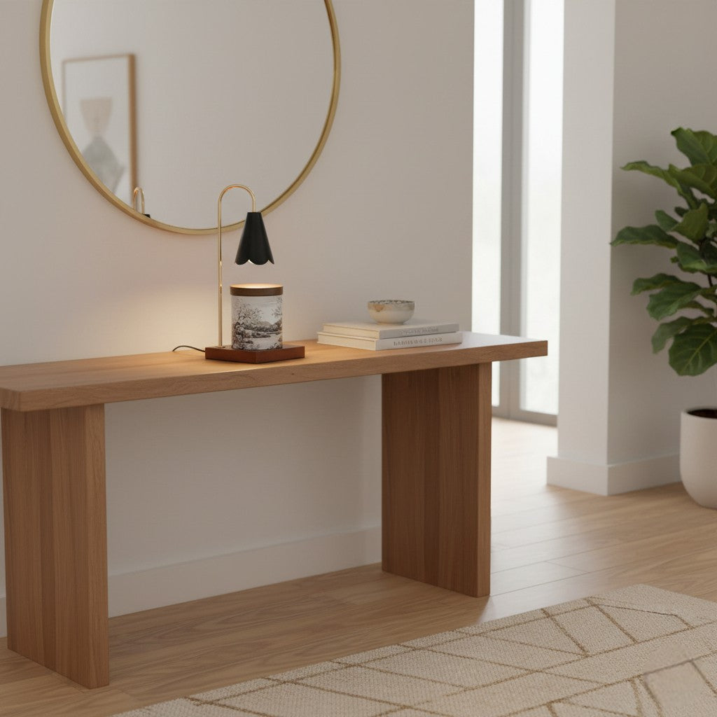 Wooden console table with decor items in a room with a mirror and plant.